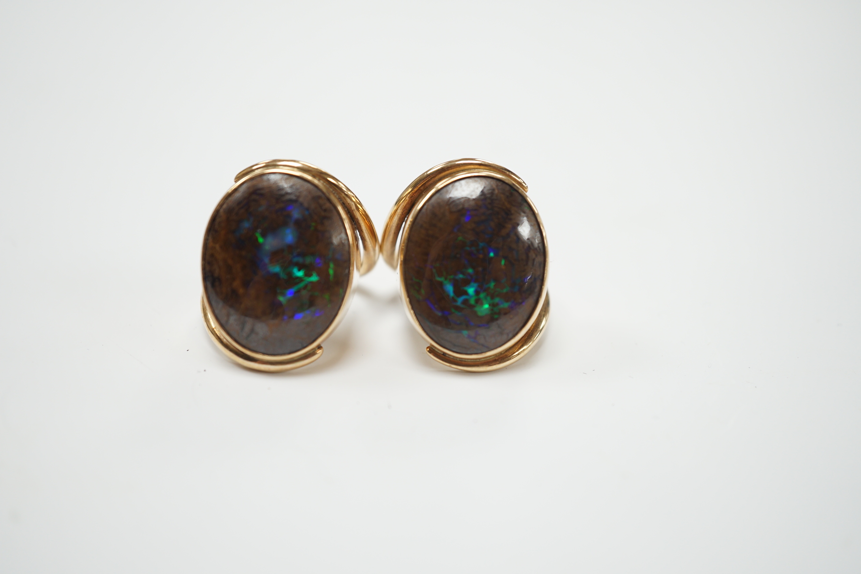 A pair of yellow metal and oval boulder opal set dress rings, both size M, gross weight 20 grams.